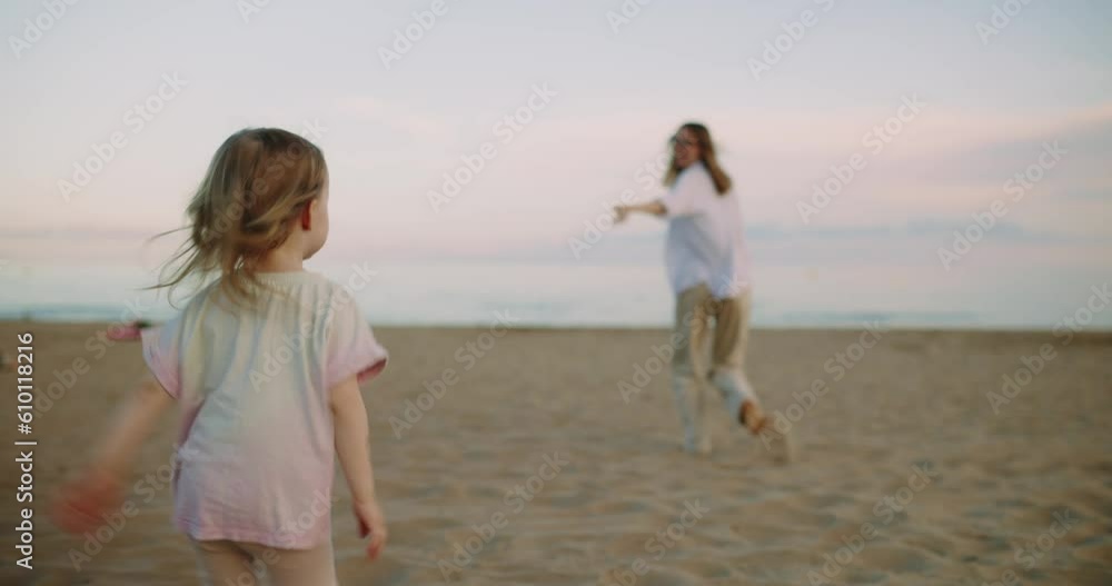 Happy family on the beach, mother and daughter running happy on the beach. A young mother with a three-year-old daughter happily laughing and playing in nature. Happy family on the beach, mother and daughter running happy on the beach. A young mother with a three-year-old daughter happily laughing and playing in nature.
