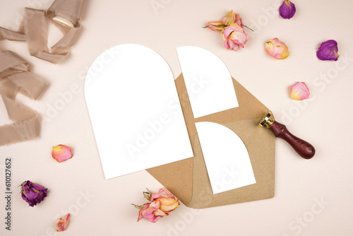 5x7 arch card wedding stationery suite mockup. Styled with silk ribbon, vintage wax seal and dried roses on a beige background. Vertical orientation with two enclosure half arch cards.