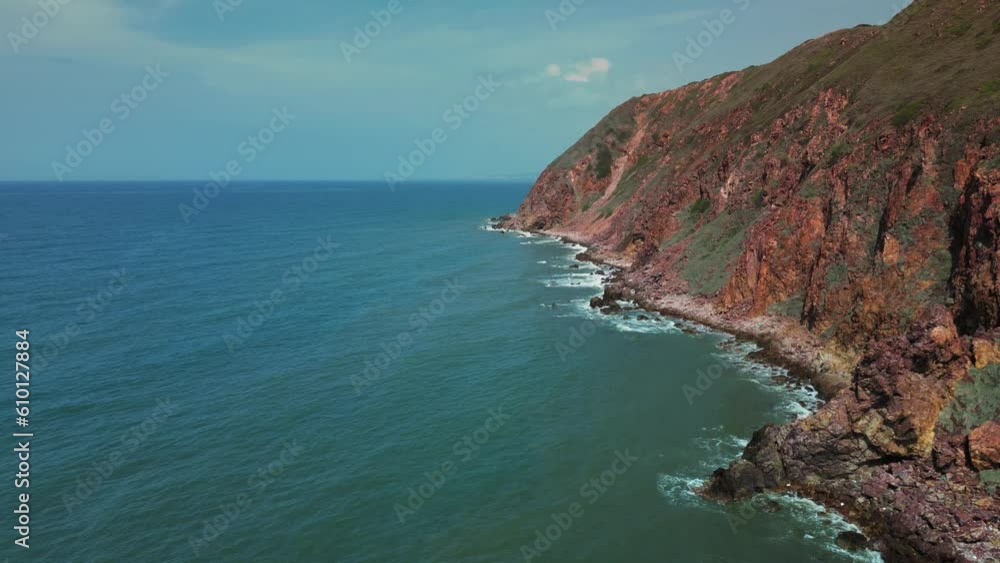 Scenic marine nature concept. Sea waves breaking over rocks mountains. Vitality of blue energy and clear ocean water. Foamy sea waves crashing at rocky pebbled seashore slow motion. 4K Scenic marine nature concept. Sea waves breaking over rocks mountains. Vitality of blue energy and clear ocean water. Foamy sea waves crashing at rocky pebbled seashore slow motion. 4K