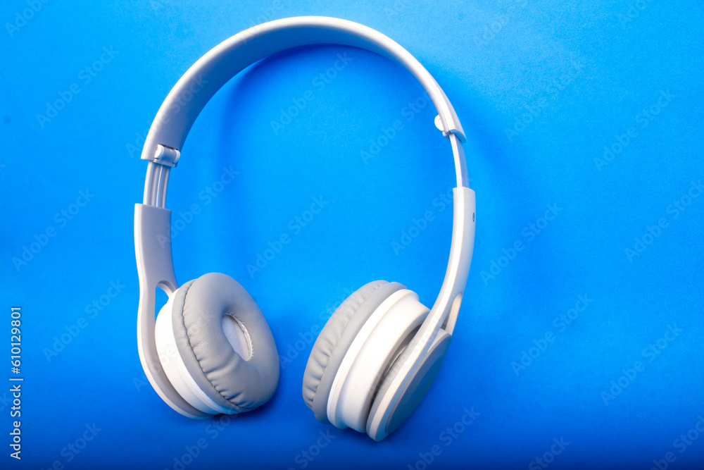 white headset isolated on blue background white headset isolated on blue background