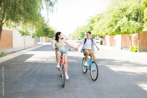 Cheerful couple dating and having fun riding their bikes