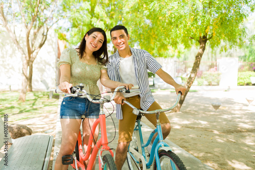 Attractive young couple going on a bike ride together in the park