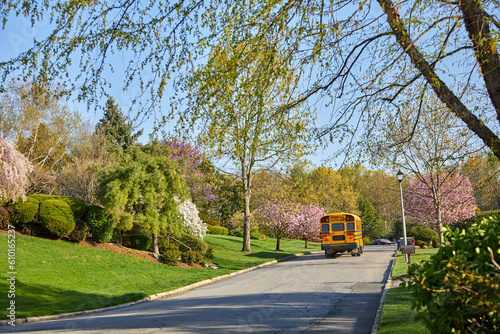 School bus picking up students in the neighborhood on a spring day in April