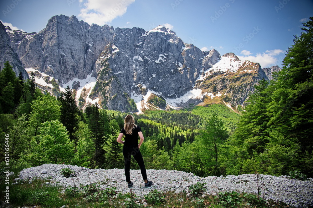 Mature woman standing at the edge of a cliff in Italian Alps