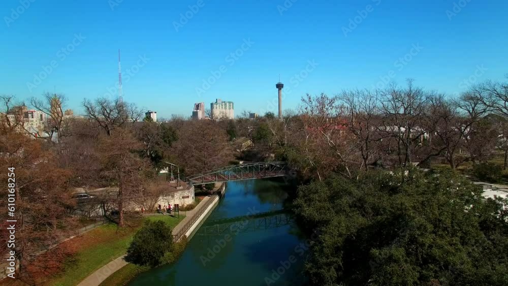 Aerial Shot Of River Canal Amidst Trees Against Sky, Drone Ascending Backward Over City On Sunny Day - San Antonio, Texas Aerial Shot Of River Canal Amidst Trees Against Sky, Drone Ascending Backward Over City On Sunny Day - San Antonio, Texas