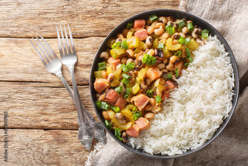 Fotografija Hoppin John or Carolina peas and rice, is a black-eyed peas and rice with vegetables dish closeup on the plate on the wooden table
