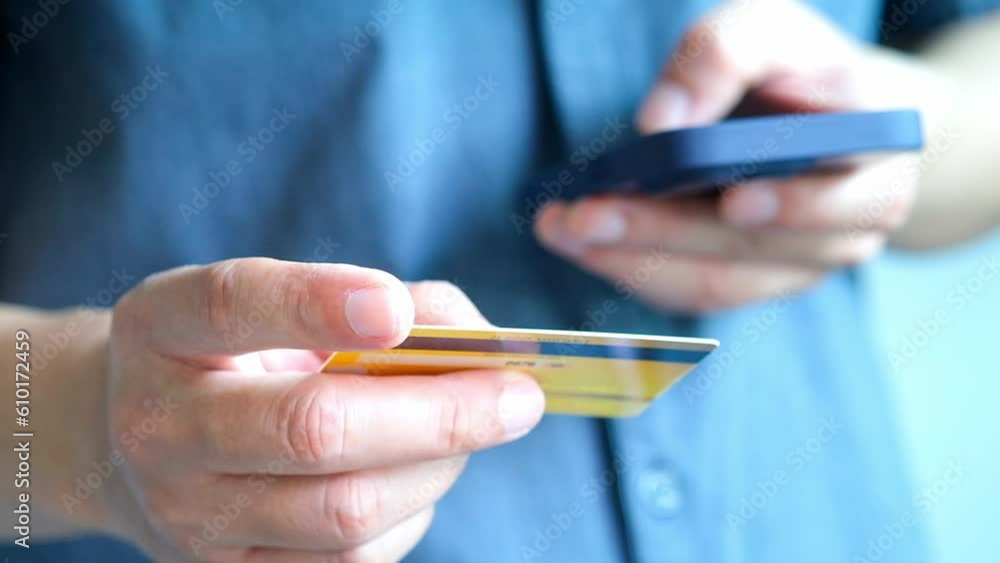 Man holding several credit cards and he is choosing a credit card to pay and spend Payment for goods via credit card. Finance and banking concept. Man holding several credit cards and he is choosing a credit card to pay and spend Payment for goods via credit card. Finance and banking concept.