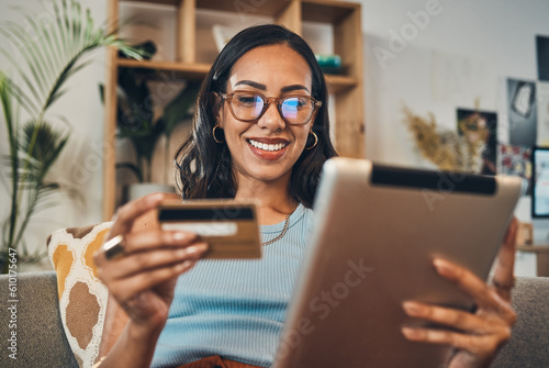 Woman on sofa with tablet, credit card and ecommerce payment for online shopping with fintech at home. Happy female customer, digital bank app and sale on store website with internet banking in house