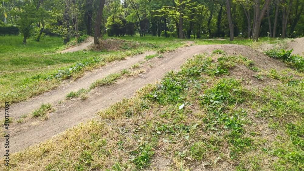 Child cycling off-road artificial hills in the park for cycling training Child cycling off-road artificial hills in the park for cycling training