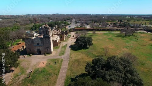 Aerial Panning Shot Of Mission San Jose Church Against Blue Sky, Drone Flying Over City On Sunny Day - San Antonio, Texas photo