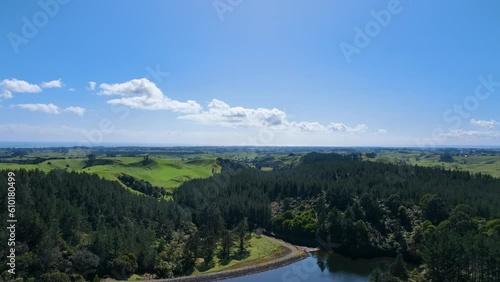 Flight over lake end, pine forest, and rich Taranaki farm land New Zealand photo