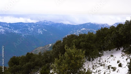 mountain with snow in algeria tellian atlas mountain chain Rays of light coming out of the clouds photo