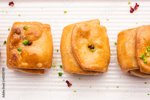 Lavang Latika: traditional Indian sweet. Crescent shape, deep-fried, soaked in sugar syrup. Served during festivals. photo