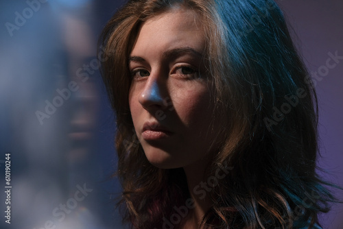 Portrait of sad teen girl looking at camera.