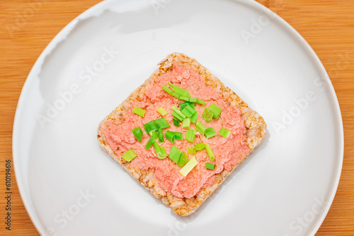 Rice Cake Sandwich with Fish Cream and Green Onions on White Plate. Easy Breakfast. Diet Food. Quick and Healthy Sandwiches. Crispbread with Tasty Filling. Healthy Dietary Snack