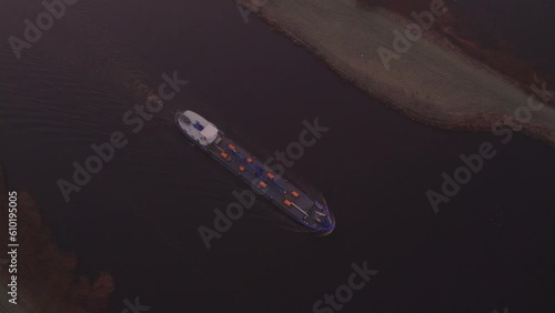 Large vessel moving past Bergum during misty morning in Burgumer Mar, aerial 4k photo