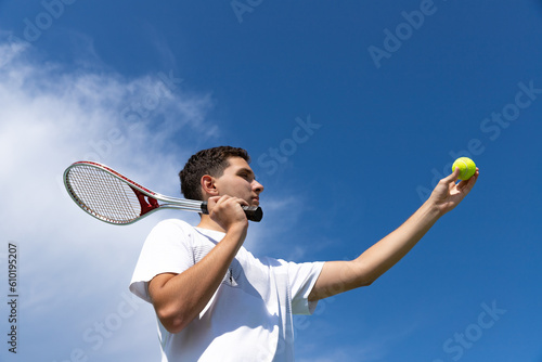 Teenager tennis player serving a ball on the tennis court