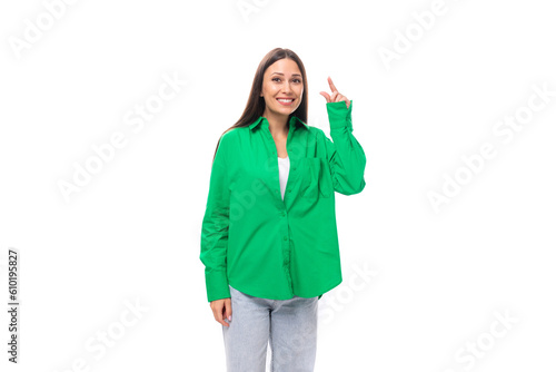 well-groomed attractive young brunette woman with makeup in a green shirt on a white background with copy space © Ivan Traimak
