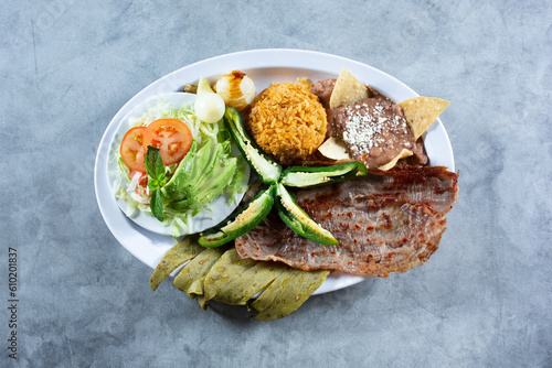 A top down view of a Mexican platter, featuring cecina and nopal. photo