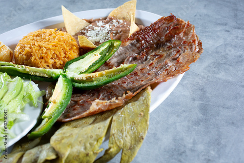 A view of a Mexican platter, featuring cecina and nopal. photo