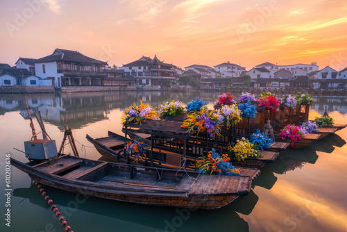 landscape with village, boats and wooden houses in sunrise photo