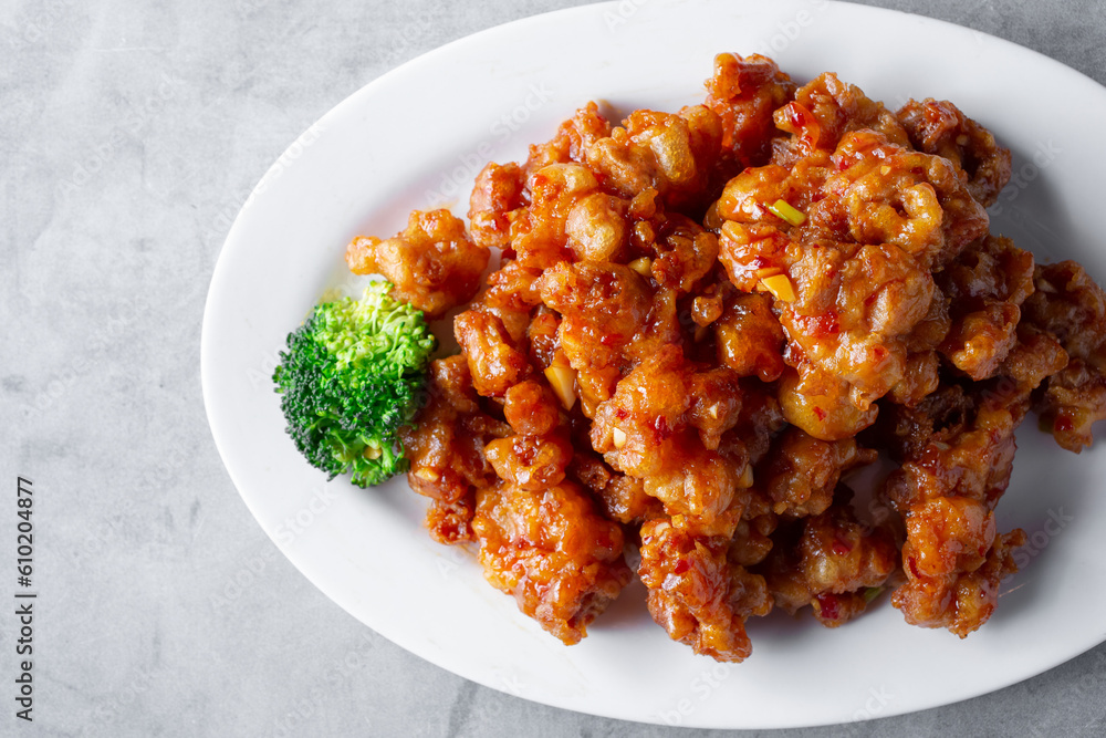 A top down view of a plate of orange chicken. A top down view of a plate of orange chicken.