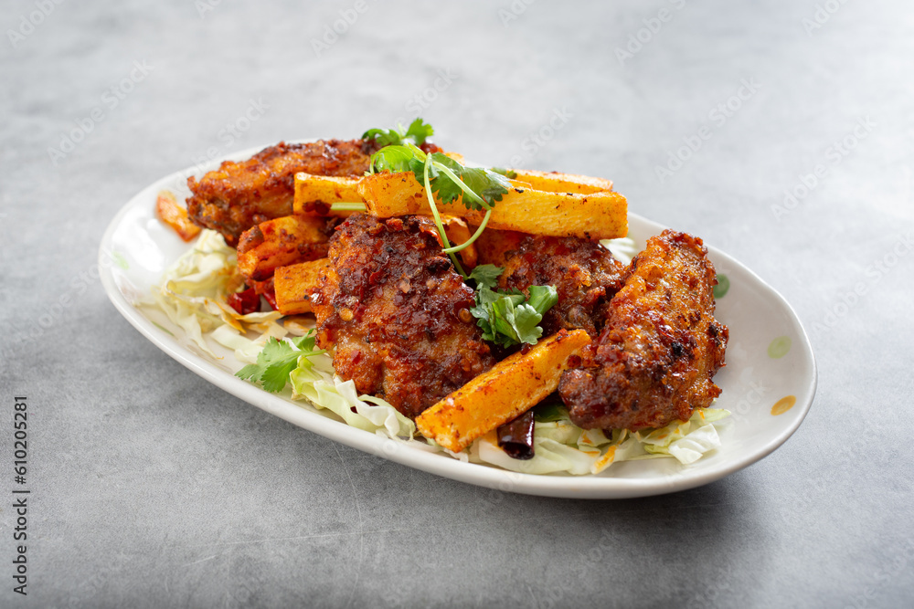 A view of a plate of Asian spicy chicken wings. A view of a plate of Asian spicy chicken wings.