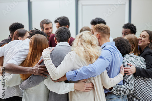 Group of happy positive smiling multiethnic men and women from different mixed race countries standing in a circle