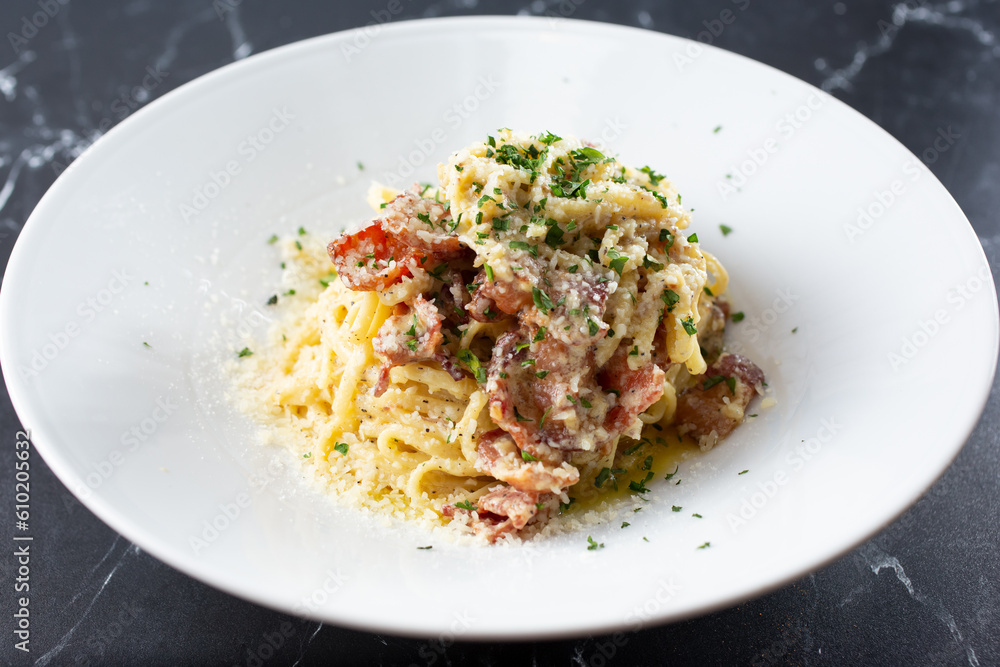 A view of a plate of pasta carbonara. A view of a plate of pasta carbonara.