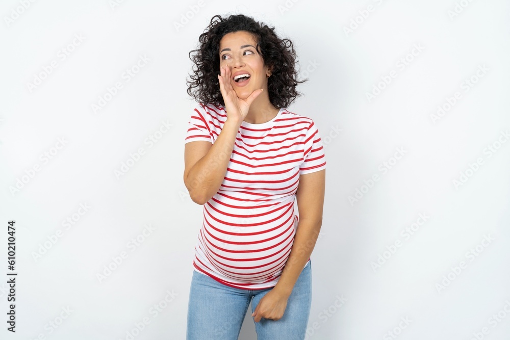 young pregnant woman wearing striped t-shirt over white background hear incredible private news impressed scream share young pregnant woman wearing striped t-shirt over white background hear incredible private news impressed scream share