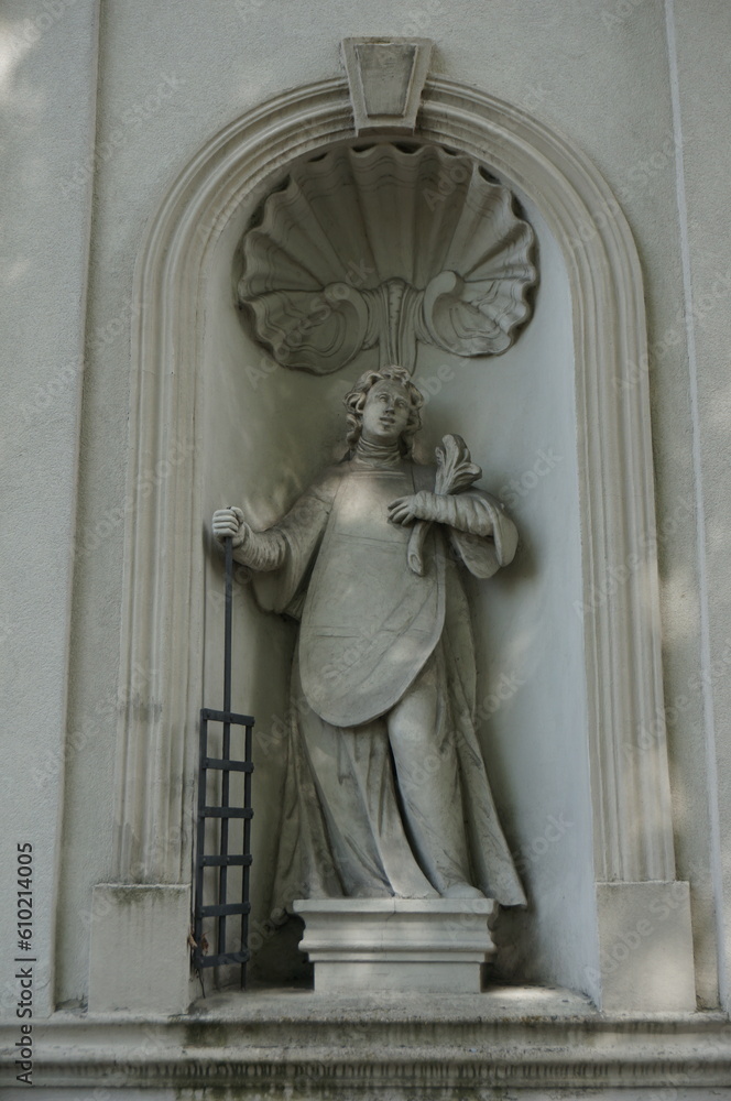Statue of Saint Lawrence in niche of Church of the Lord's Transfiguration facade. Ogrodzieniec, Poland.