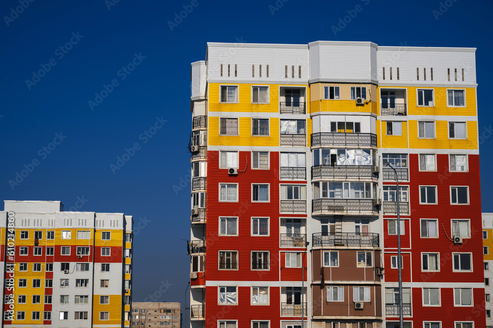 residential new houses with windows and balconies on a blue sky background