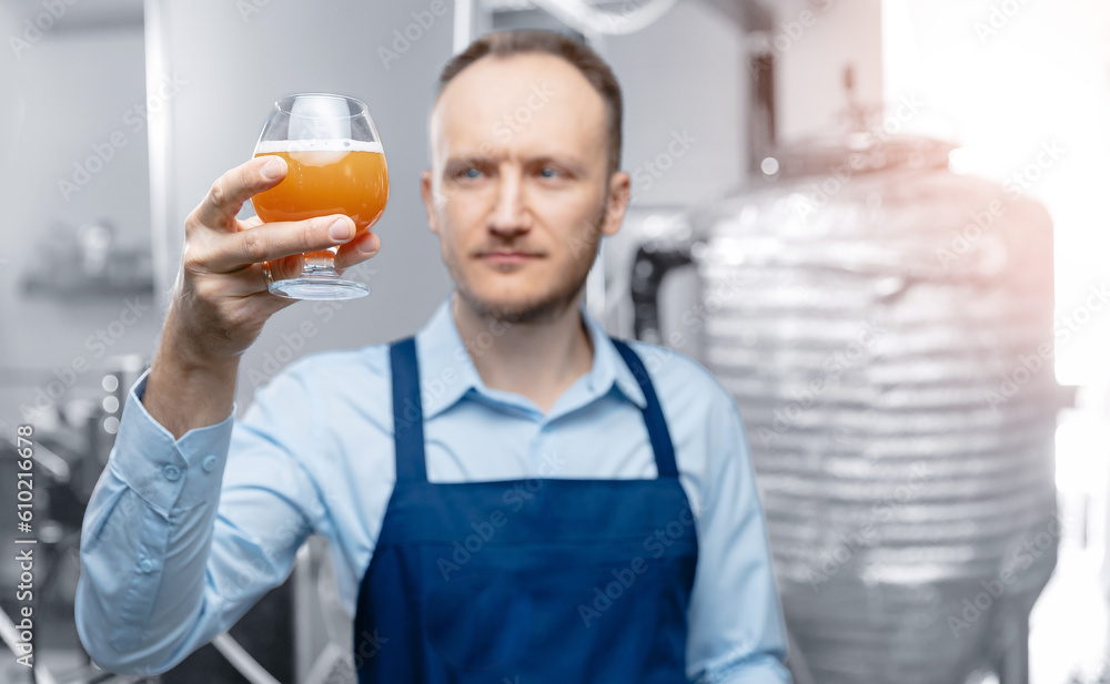 Quality control beer mead, worker tests and evaluates taste of drink at brewery Quality control beer mead, worker tests and evaluates taste of drink at brewery
