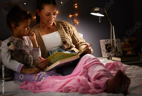 Fotografie Night, book and reading with mother and daughter in bedroom for creative storytelling, fantasy and home