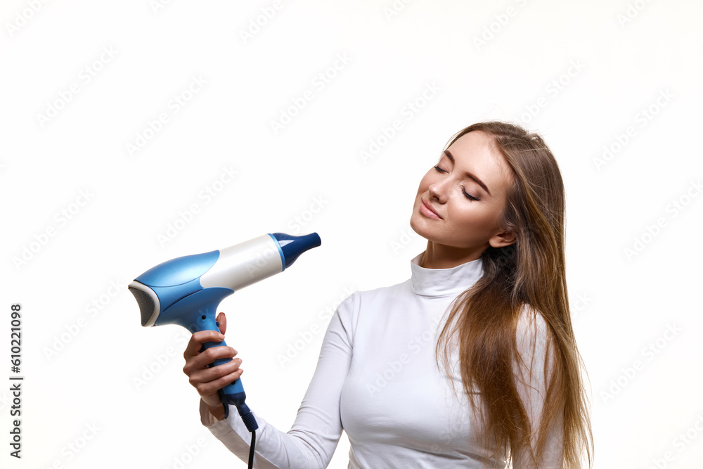 Portrait of attractive cheerful girl drying long hair Portrait of attractive cheerful girl drying long hair