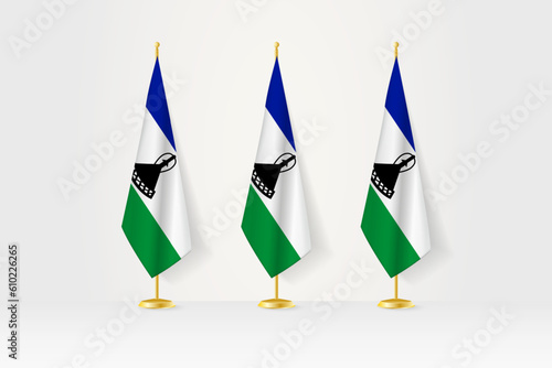 Three Lesotho flags in a row on a golden stand, illustration of press conference and other meetings.
