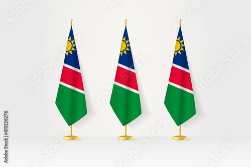 Three Namibia flags in a row on a golden stand, illustration of press conference and other meetings.