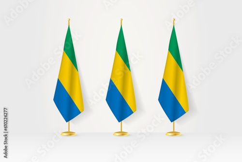 Three Gabon flags in a row on a golden stand, illustration of press conference and other meetings.