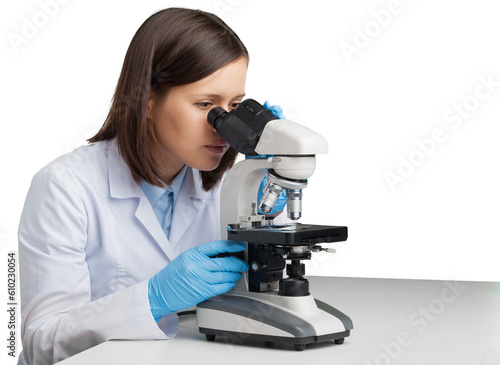 Young woman medical researcher looking through a modern microscope in a laboratory