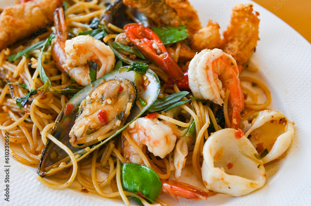 noodles plate with spaghetti pasta stir fried with vegetables herb spicy tasty appetizing asian noodles mix seafood stir fried shrimp squid shellfish fish with basil and chilli pepper noodles plate with spaghetti pasta stir fried with vegetables herb spicy tasty appetizing asian noodles mix seafood stir fried shrimp squid shellfish fish with basil and chilli pepper
