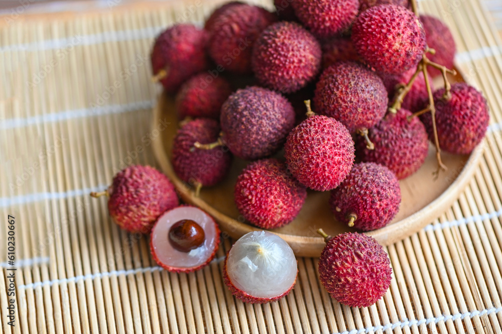 fresh ripe lychee fruit tropical fruit peeled lychees slice in Thailand, lychees on wooden plate