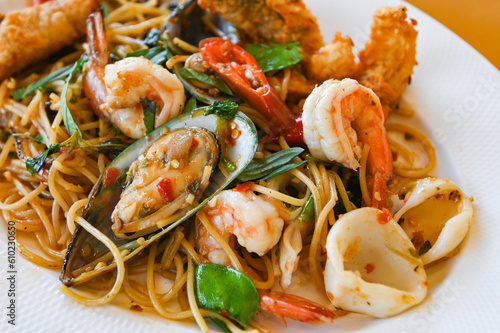 noodles plate with spaghetti pasta stir fried with vegetables herb spicy tasty appetizing asian noodles mix seafood stir fried shrimp squid shellfish fish with basil and chilli pepper