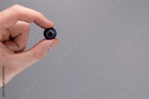 Hand holding blueberry, concept of healthy food, diet. copy space for text