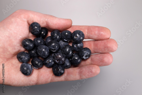 Handful of fresh blueberry in hand