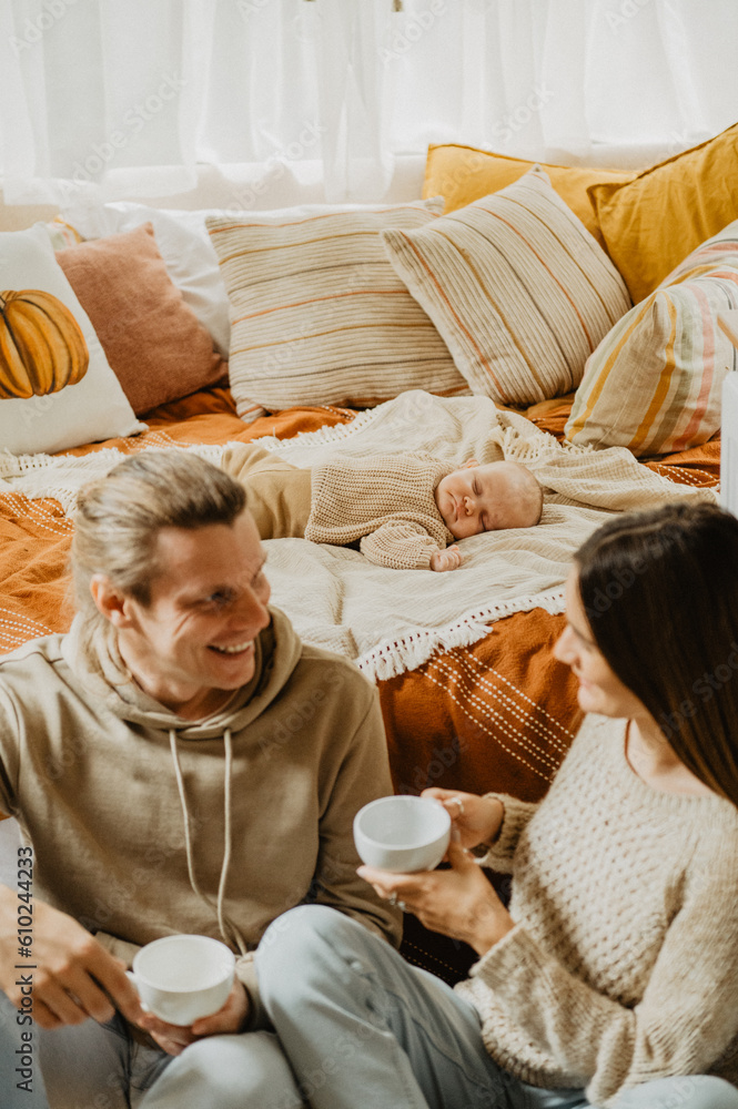 Young mother and father with their little daughter hugging and kissing on the bed. Young mother and father with their little daughter hugging and kissing on the bed.