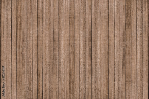 Image of vintage hardwood board with rough surface. Close up pattern and textured from old plank wooden wall with soft light. Natural brown color background.