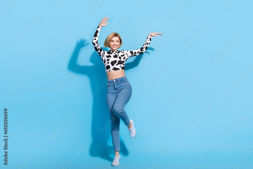 Full body photo of positive cheerful crazy lady dancing partying isolated on blue color background Full body photo of positive cheerful crazy lady dancing partying isolated on blue color background