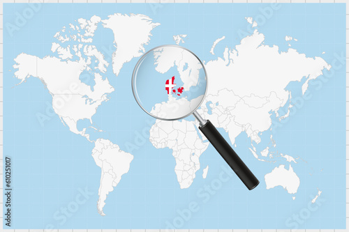Magnifying glass showing a map of Denmark on a world map.
