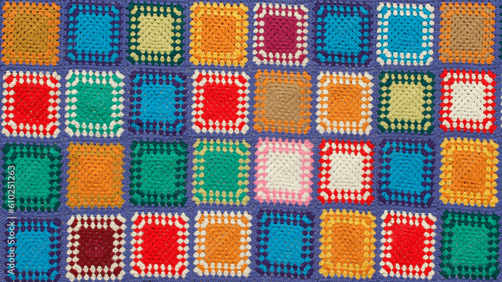 Detail of a crocheted patchwork multicolor wool blanket.