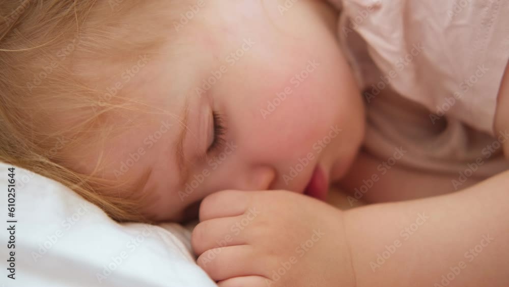 Peaceful adorable baby sleeping on his bed at home. Sleeping newborn baby concept. One year old baby girl sleeps peaceful at domestic room interior background. Serene dream. Cute Face Close Up. Peaceful adorable baby sleeping on his bed at home. Sleeping newborn baby concept. One year old baby girl sleeps peaceful at domestic room interior background. Serene dream. Cute Face Close Up.